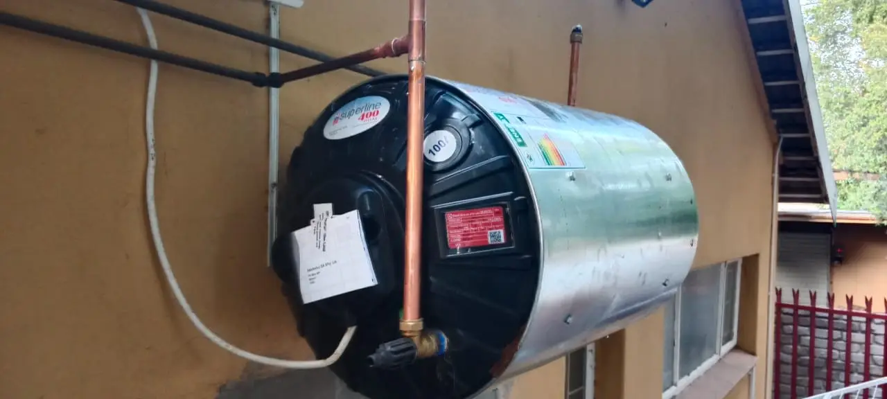 Unique Fix technician installing an electric geyser